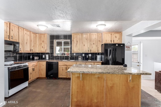 kitchen featuring visible vents, plenty of natural light, black appliances, and light brown cabinets