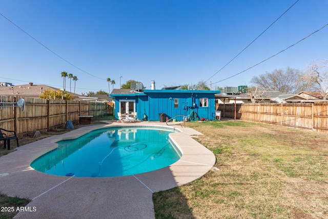 view of pool with central AC, a lawn, a fenced in pool, and a fenced backyard