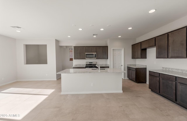 kitchen with visible vents, dark brown cabinetry, an island with sink, recessed lighting, and stainless steel appliances