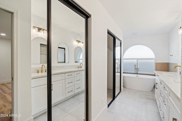 bathroom featuring a tub to relax in and vanity