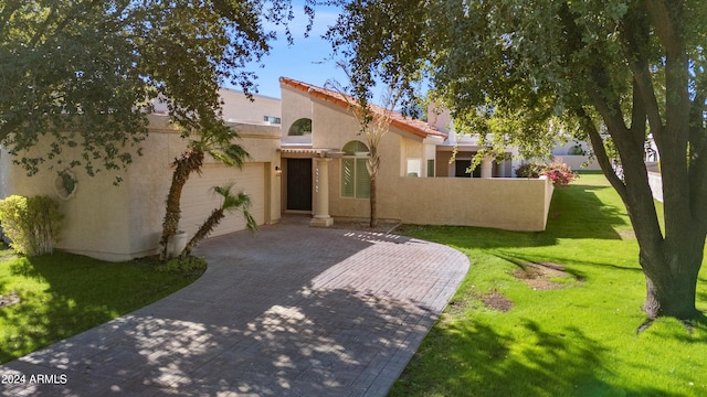 mediterranean / spanish-style home with a front yard