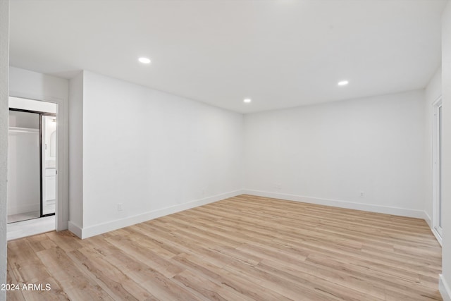 empty room with light hardwood / wood-style flooring