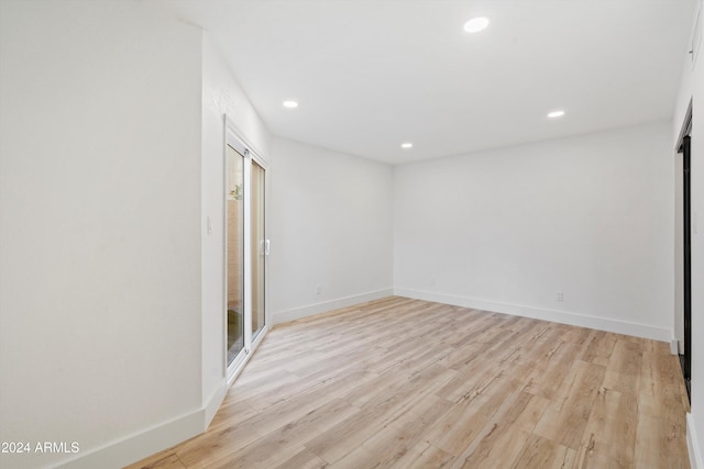 unfurnished room with light hardwood / wood-style floors