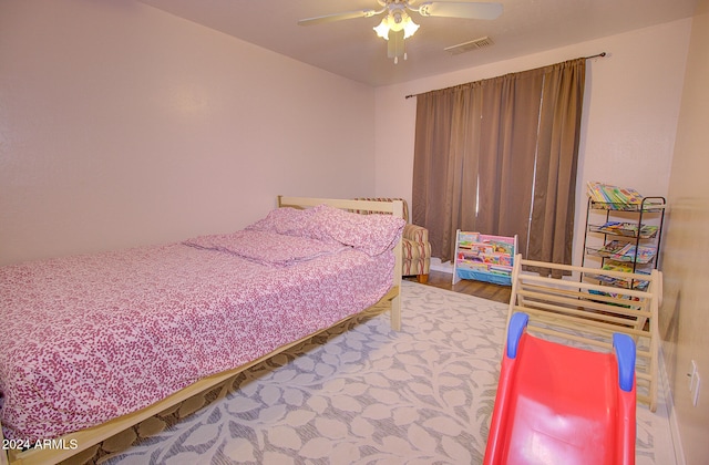 bedroom with hardwood / wood-style floors and ceiling fan