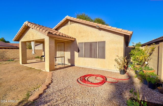 back of house with a patio