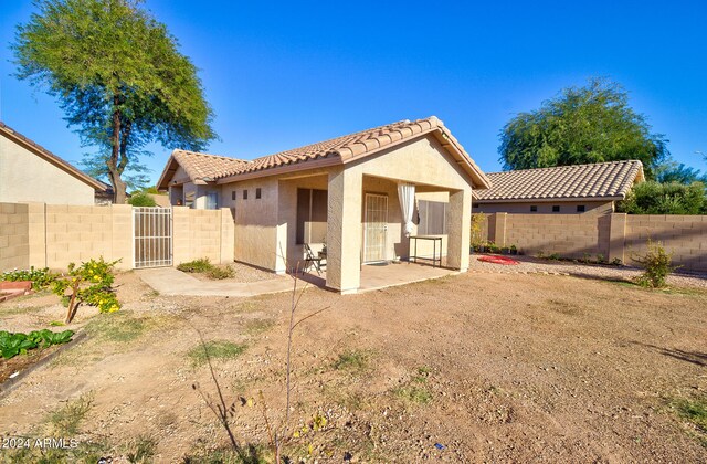 back of property with a patio area