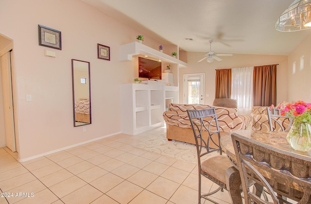 dining room featuring light tile patterned floors, ceiling fan, and vaulted ceiling