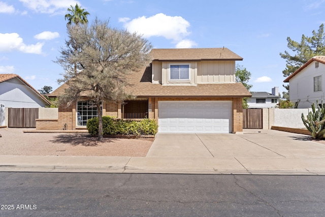 traditional-style home featuring concrete driveway, an attached garage, fence, and brick siding
