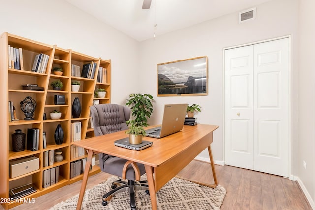 home office featuring wood-type flooring and ceiling fan