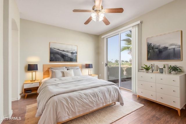 bedroom featuring access to exterior, hardwood / wood-style floors, and ceiling fan