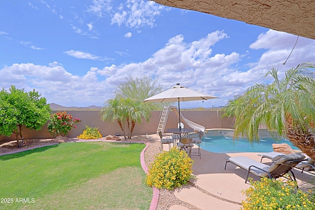 view of pool with a water slide and a patio