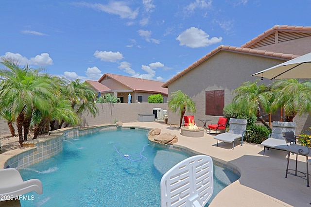 view of pool with a patio area, fence, and a water slide