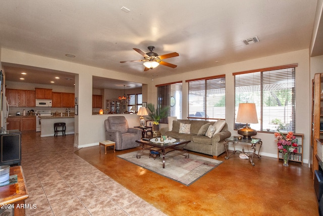 living room with ceiling fan and light tile patterned flooring