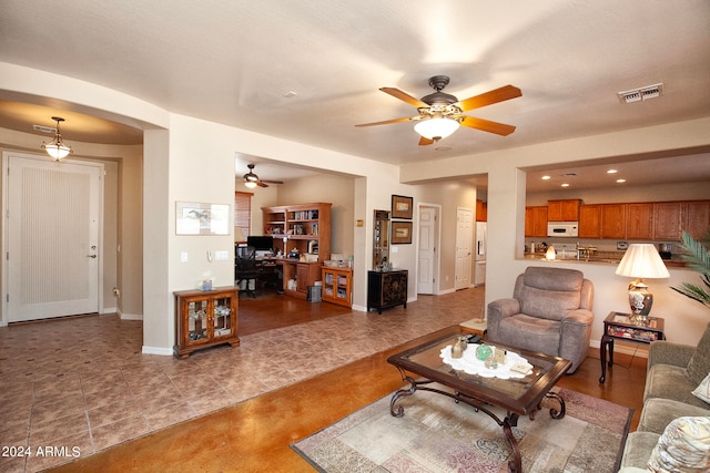 tiled living room featuring ceiling fan