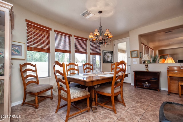 tiled dining space with a notable chandelier