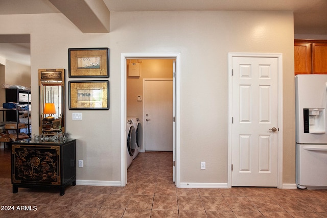 interior space featuring independent washer and dryer and tile patterned flooring