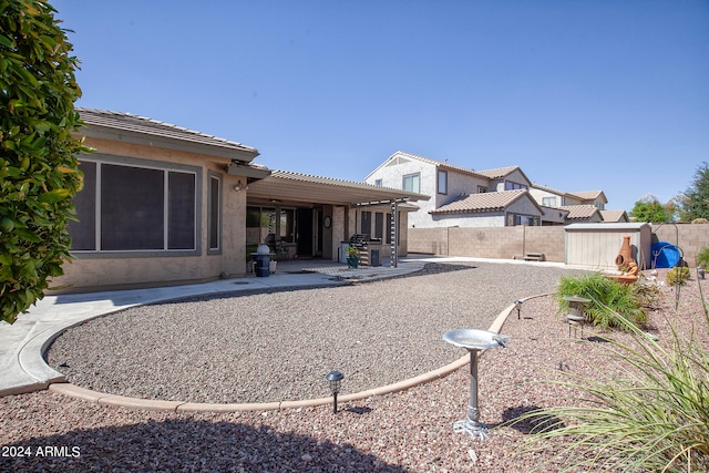 view of yard featuring a patio area and a storage shed