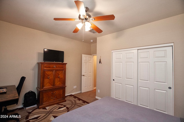 carpeted bedroom featuring a closet and ceiling fan