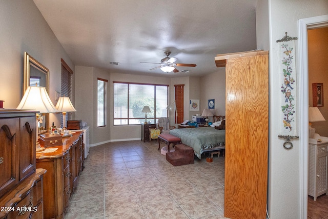 tiled bedroom featuring ceiling fan