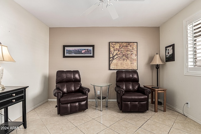 living area featuring ceiling fan and light tile patterned floors