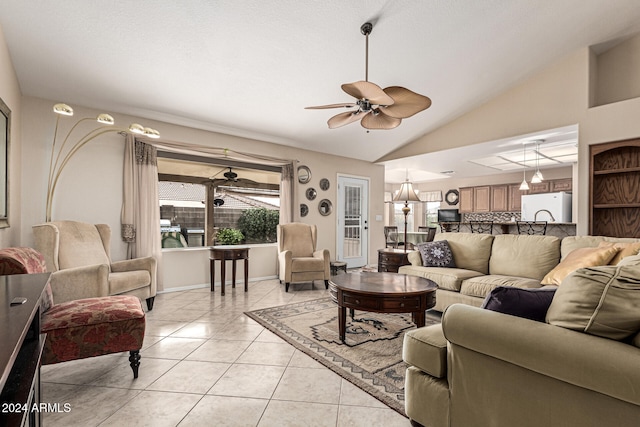 tiled living room featuring ceiling fan and high vaulted ceiling