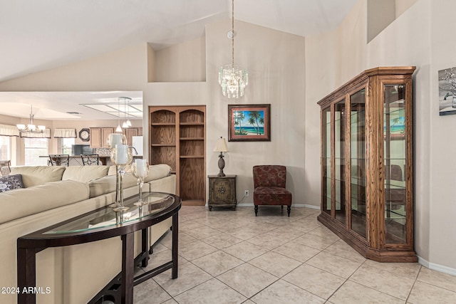 living room with light tile patterned floors, high vaulted ceiling, and an inviting chandelier