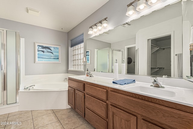 bathroom with tile patterned floors, vanity, and independent shower and bath