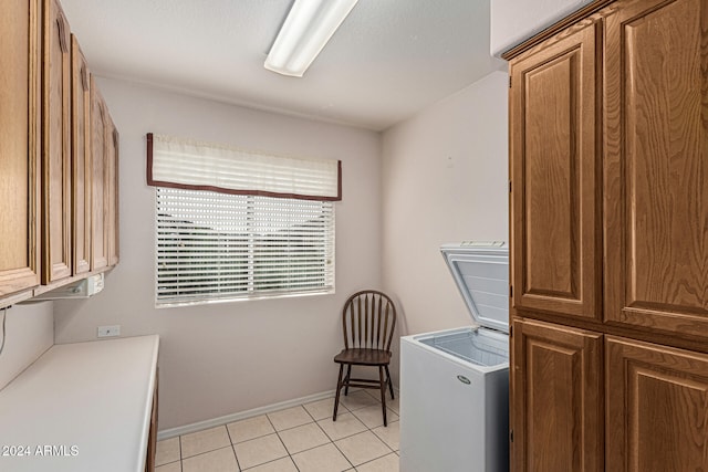 laundry area with light tile patterned floors