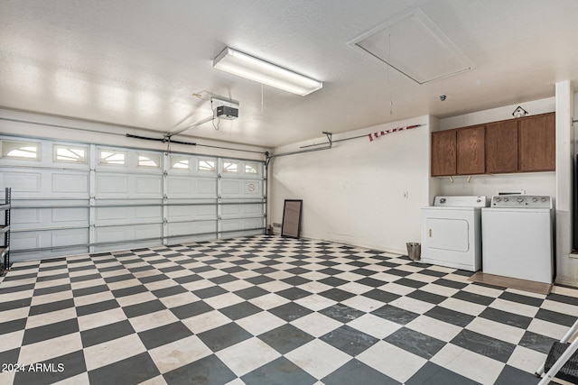 garage featuring a garage door opener and washing machine and clothes dryer