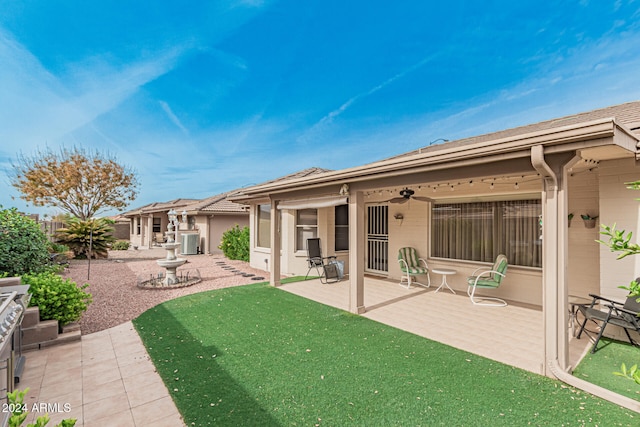 rear view of house with central air condition unit, a patio area, and ceiling fan