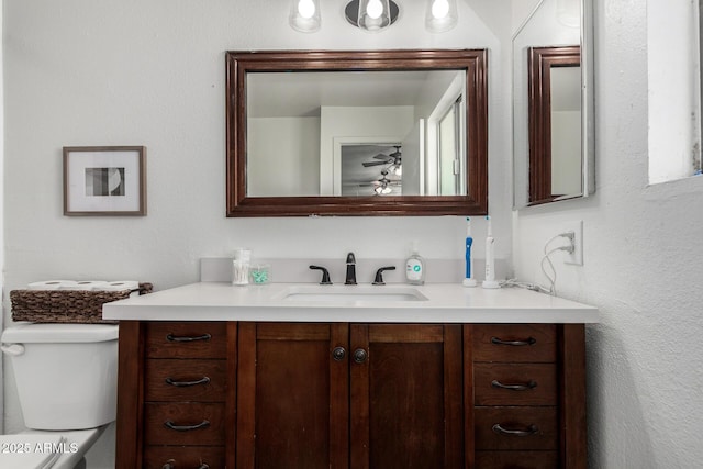 9046 N 51st Ln, Glendale, AZ 85302 - half bath with vanity, a ceiling fan, and toilet