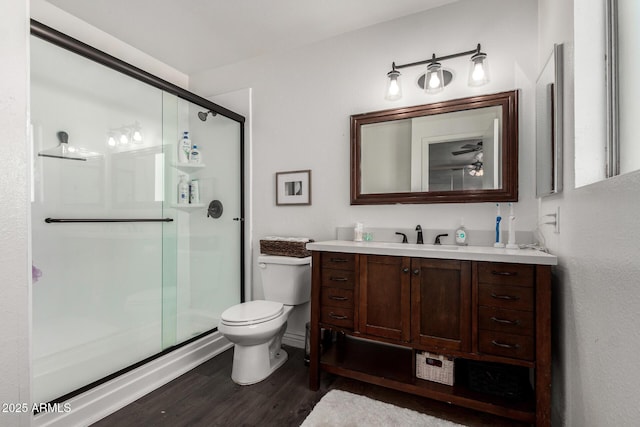 9046 N 51st Ln, Glendale, AZ 85302 - bathroom featuring a shower stall, vanity, toilet, and wood finished floors