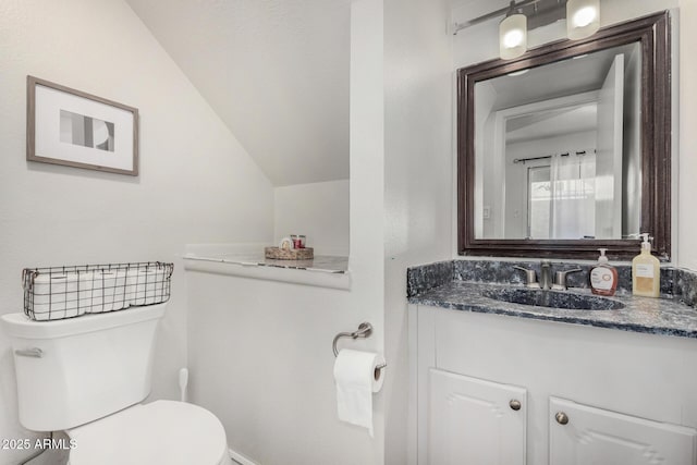 9046 N 51st Ln, Glendale, AZ 85302 - bathroom with toilet, vanity, and lofted ceiling