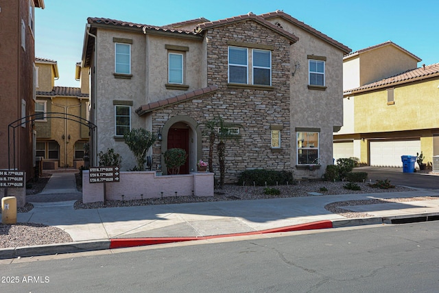 mediterranean / spanish-style home with a garage