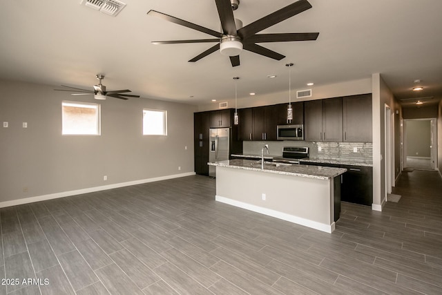 392 Schoppman Ln, Page, AZ 86040 - kitchen with visible vents, open floor plan, ceiling fan, an island with sink, and appliances with stainless steel finishes