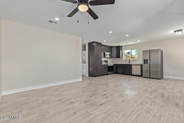 kitchen with ceiling fan, stainless steel appliances, and light hardwood / wood-style floors