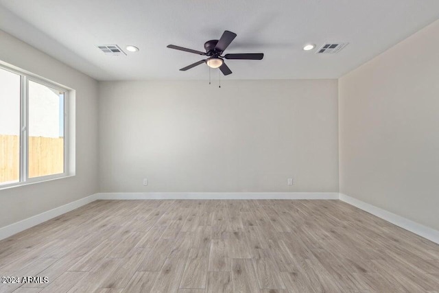 spare room with ceiling fan and light wood-type flooring