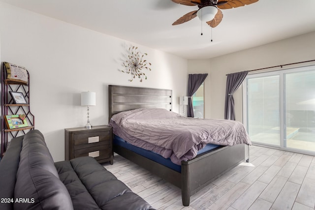 bedroom with light hardwood / wood-style floors, access to exterior, and ceiling fan