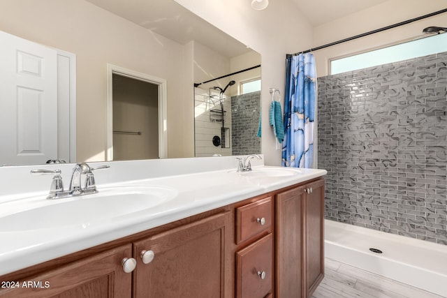 bathroom featuring wood-type flooring, a shower with shower curtain, and vanity