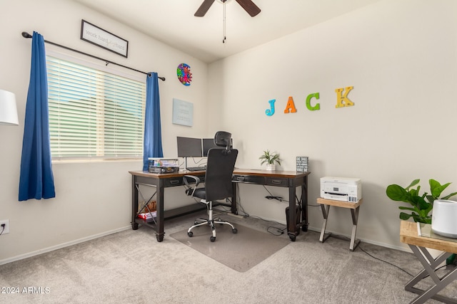 carpeted home office featuring ceiling fan