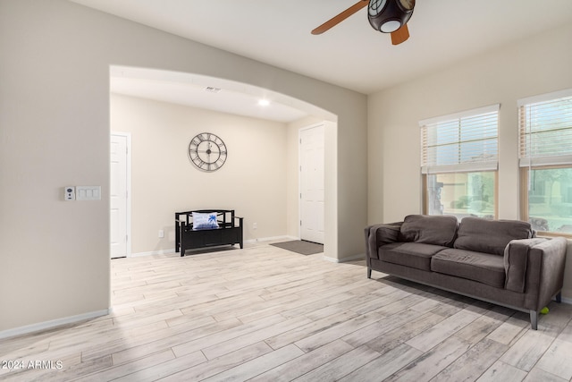 living room with ceiling fan and light hardwood / wood-style floors