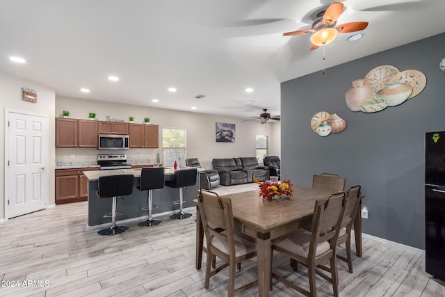 dining space featuring ceiling fan and light hardwood / wood-style flooring