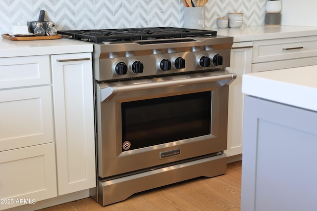 room details with white cabinetry and high end range