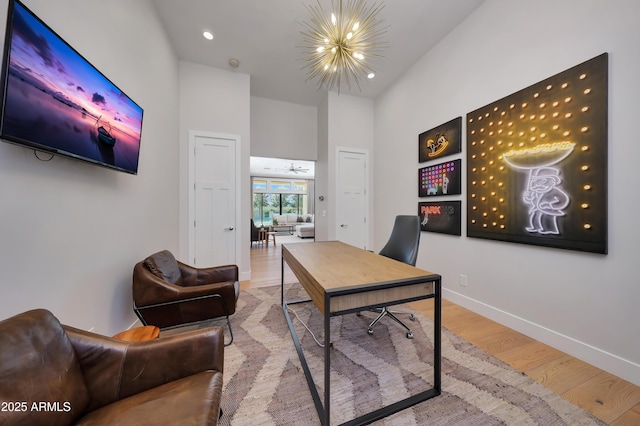 home office featuring an inviting chandelier and wood-type flooring