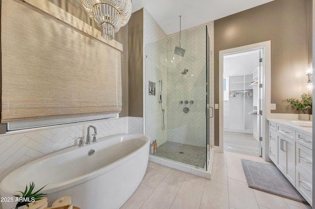 bathroom with vanity, tile patterned floors, shower with separate bathtub, and an inviting chandelier