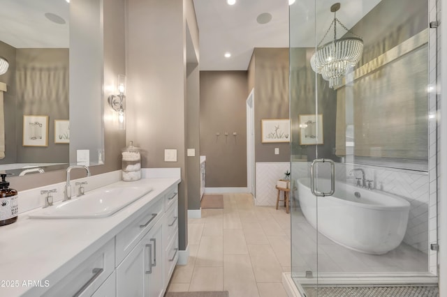 bathroom featuring vanity, a notable chandelier, tile patterned floors, and a bathing tub