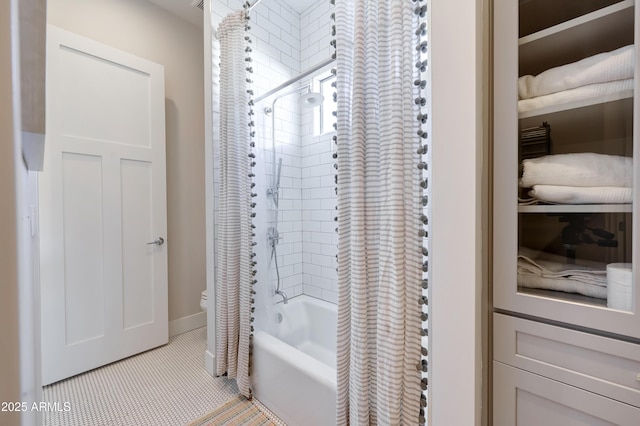 bathroom featuring tile patterned flooring, toilet, and shower / bath combo