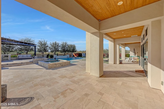 view of patio / terrace with a pool with hot tub