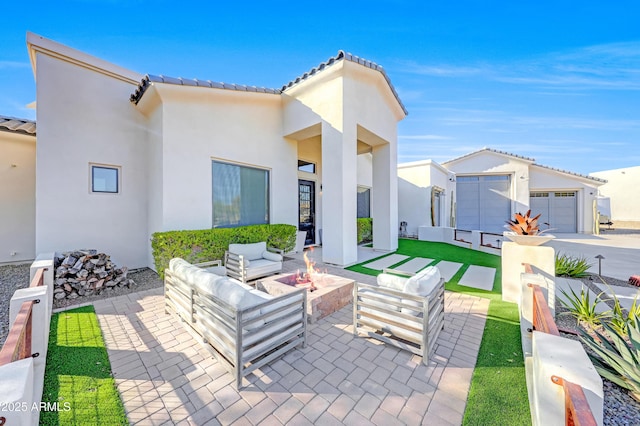 view of patio / terrace featuring an outbuilding and an outdoor living space with a fire pit