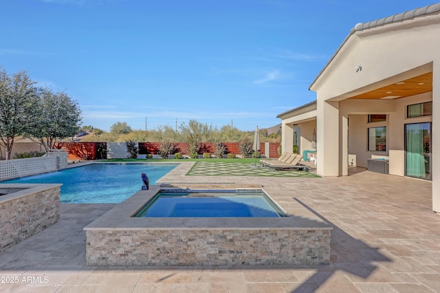 view of pool with an in ground hot tub and a patio area